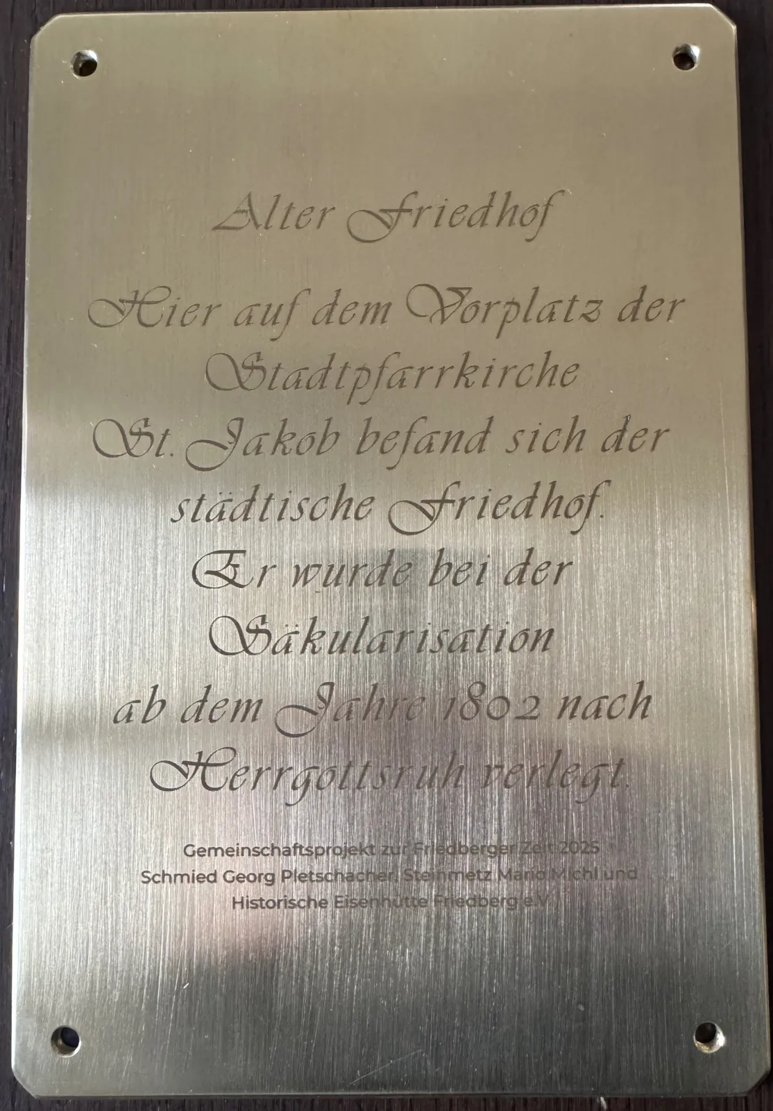 Messingfarbene Gedenktafel mit graviertem Text
